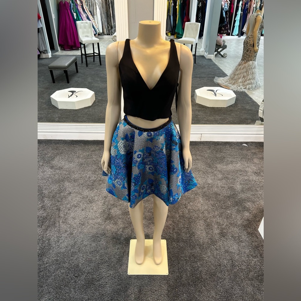 size 4. black and aqua color. 2 piece. skater skirt. pockets. ruffled back